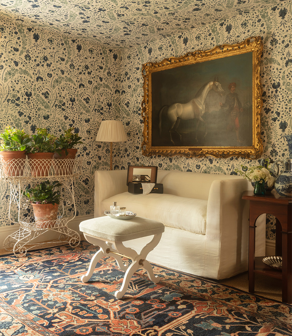 Papyrus Ivory upholstered on a sofa in a blue floral living room 