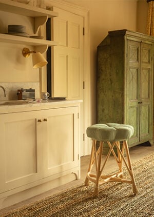 The Rattan Upholstered Venus Counter Height Stool: lifestyle