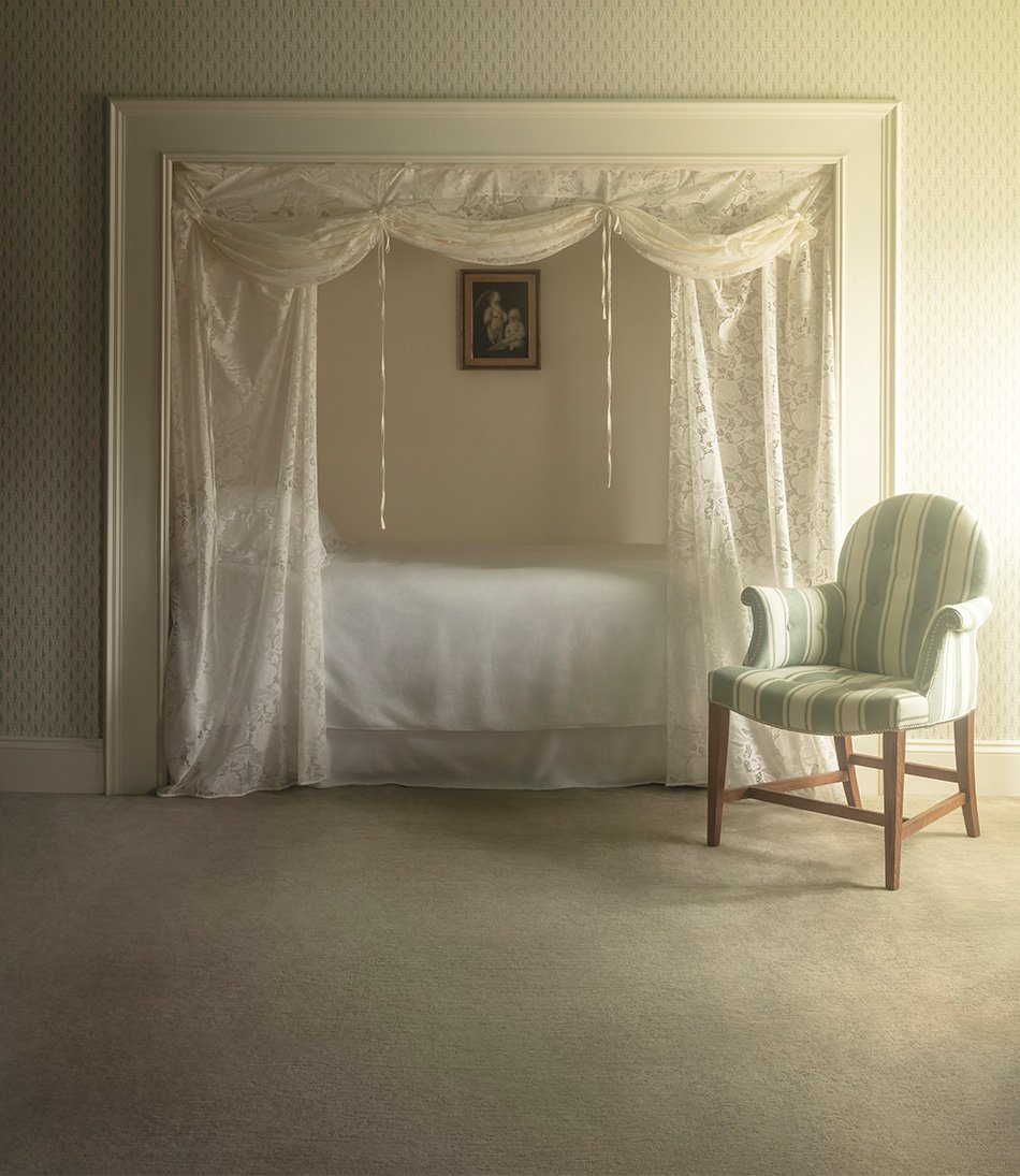 Bloomsbury Lace curtain over a single bed and a blue and white chair