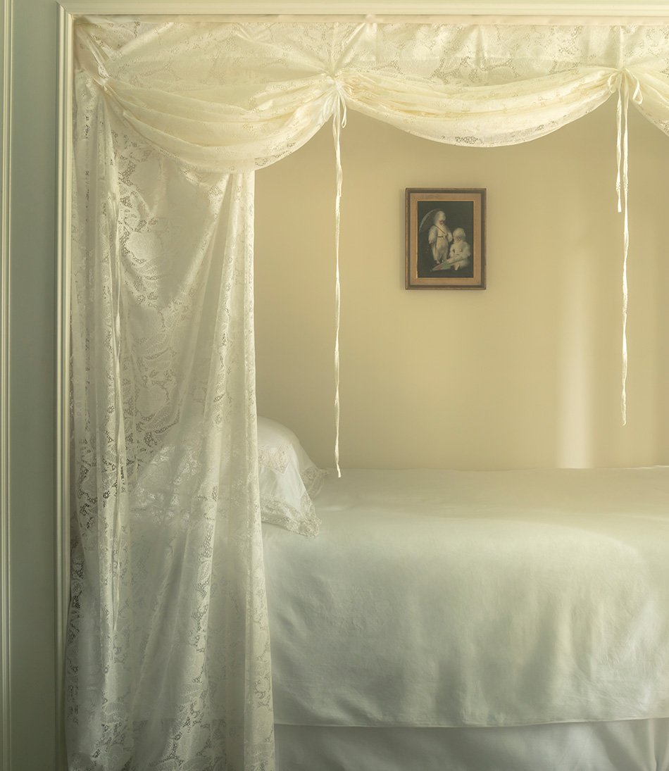 Bloomsbury Lace curtain over a single bed