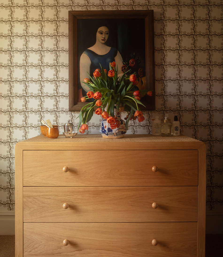Espalier Chestnut wallpaper with a rattan chest of drawers