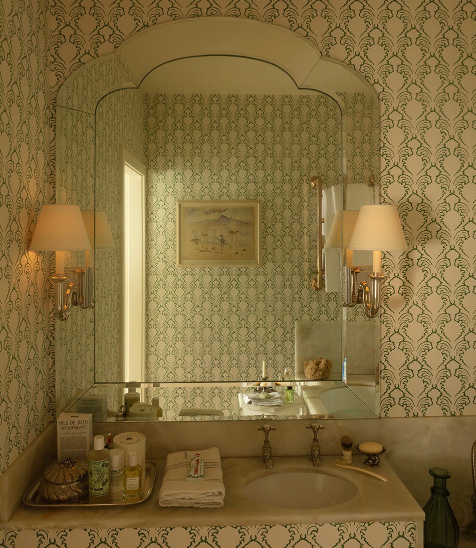Etched Pineapple Wallpaper in a bathroom with silver wall lights 
