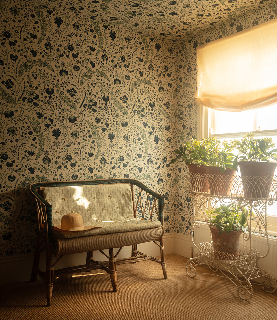 Etoile Cream fabric as a shade in a blue an white floral room with a antique rattan bench