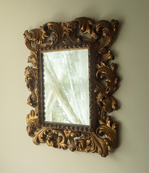 Hortense Lace as a curtain through the reflection of a small ornate mirror
