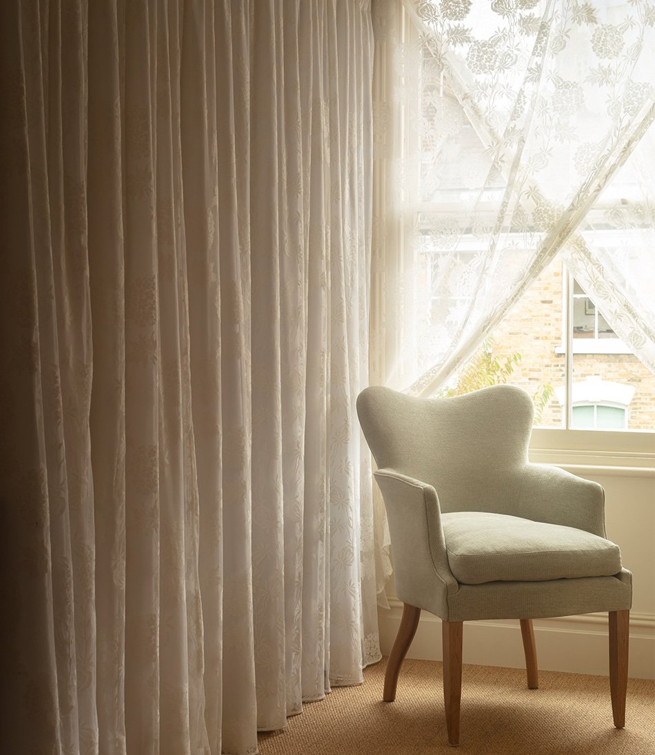 Hortense Lace as a curtain behind a pale blue armchair