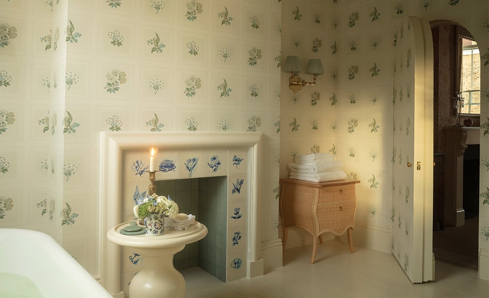 Linnaeus Original Wallpaper in bathroom with a bathtub table and candle