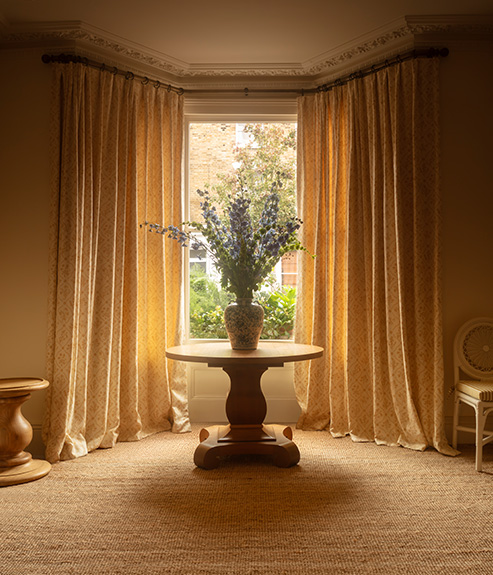 Lucknawi Flower Straw large curtains behind a round table