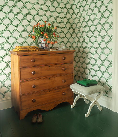 Seaweed Lace Emerald wallpaper with an antique chest of drawers and small stool
