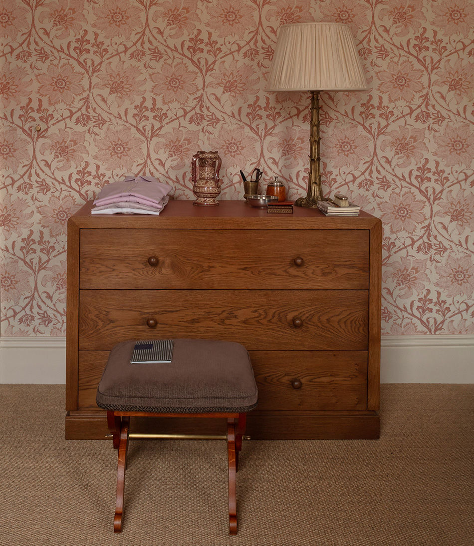 Mole Chestnut upholstered stool in front of a chest of draws