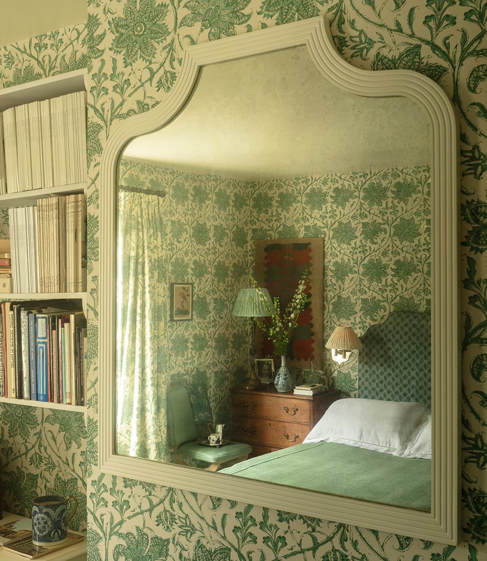 Palampore Blossom Emerald wallpaper in a bedroom with a green bed