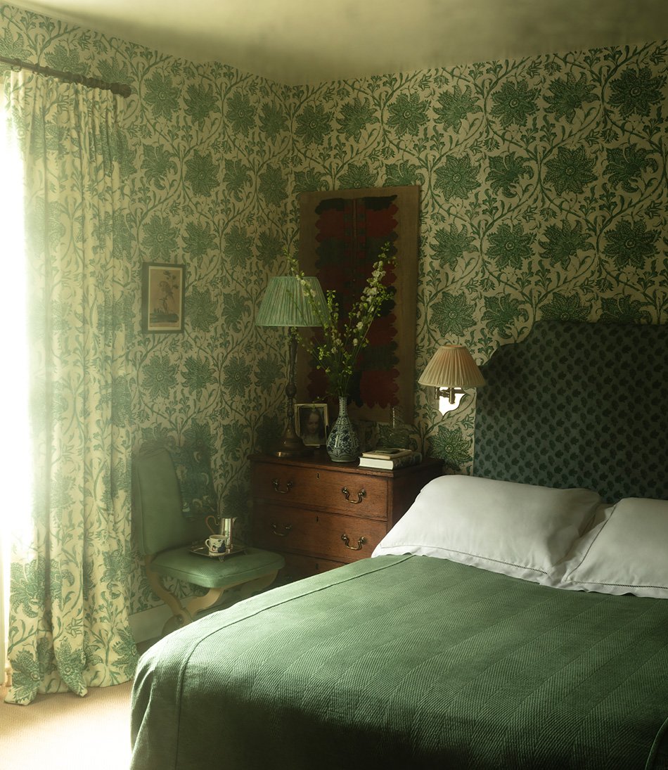 Palampore Blossom Emerald wallpaper in a bedroom with a green bed