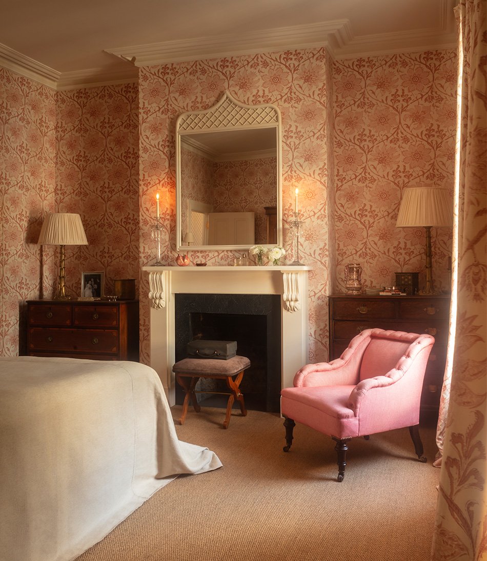 Palampore Blossom Indian Pink wallpaper in a bedroom with a fireplace