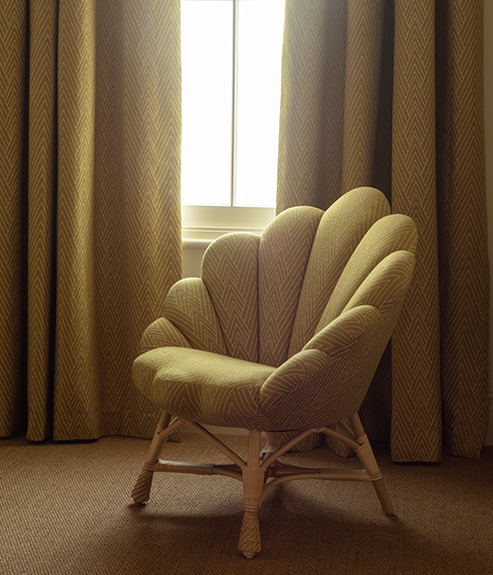 Philae Old Gold upholstered on a chair and curtains 