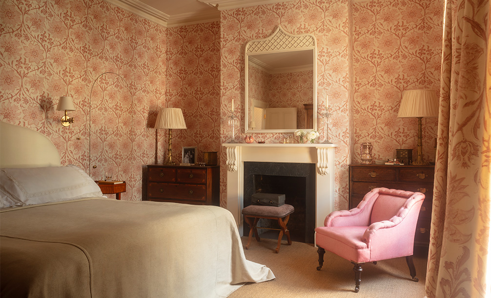 Alexis stool in a busy bedroom with a large white mirror and a fireplace 