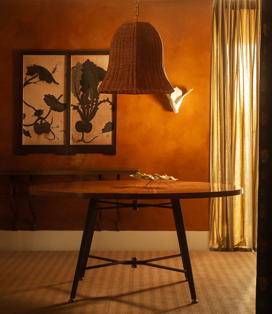 The Gambado Table with a large rattan hanging light 