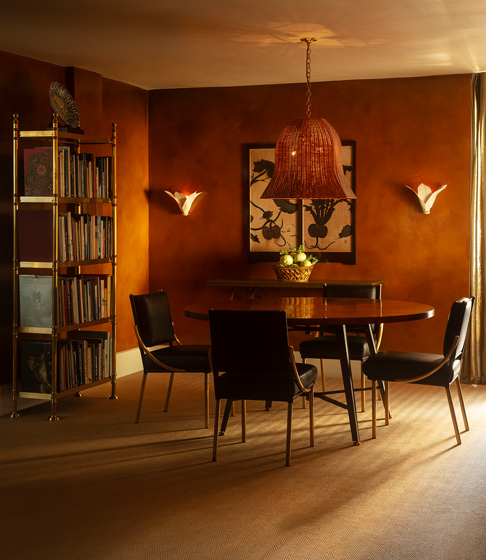 The Gambado Table with four leather chairs and a large rattan hanging light 
