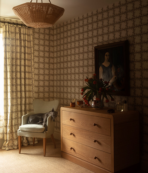 The Gigi chair with a rattan chest of drawers and a rattan hanging light